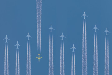 Row of airplanes flying by with one in the other direction