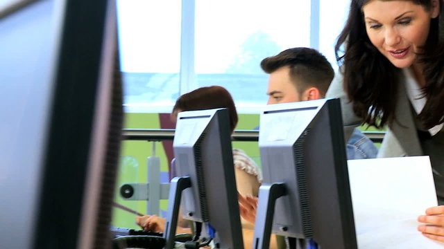 IT teacher learning on computer classmates 