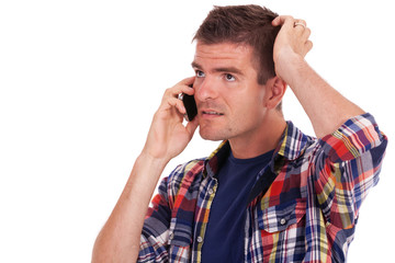 confused young man on the phone