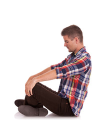 young man sitting looking down