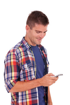 Young casual man reading an sms