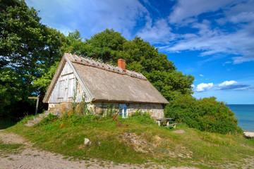 Fototapeta na wymiar Traditional Swedish cottage house at Baltic Sea