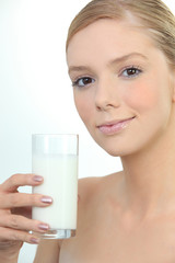 Woman holding glass of fresh milk