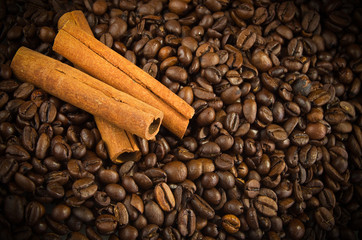 Cinnamon Sticks on the coffee beans background
