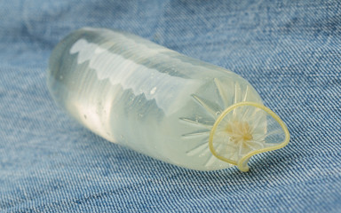 Condom filled with water on jeans