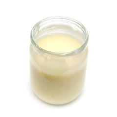 milk in a pot on a white background