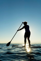 Woman on Stand Up Paddle Board at Sunset