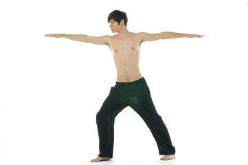 Fototapeta na wymiar Young man doing yoga in the room