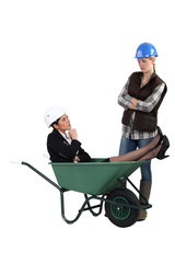 Unhappy tradeswoman finding an engineer in her wheelbarrow
