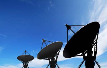 satellite dish antennas under blue sky with white cloud