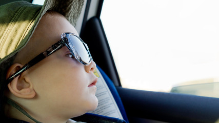 Young boy in oversized sunglasses