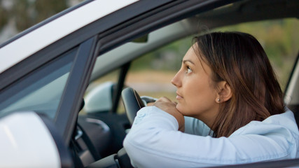 Woman waiting patiently in her car