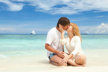 Young couple on the beach of sea