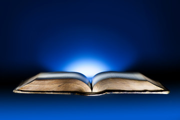 Old book, mystical blue light background