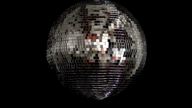 a funky discoball spinning and reflecting light. club visuals
