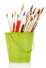 Paint brushes with gouache in bucket isolated on white © Africa Studio