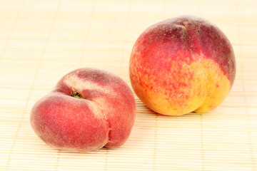 ripe peaches on bamboo mat