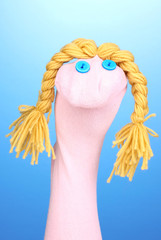 Cute sock puppet on blue background