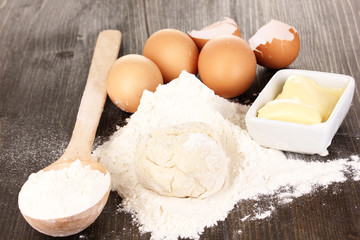 Eggs, flour and butter close-up on wooden table