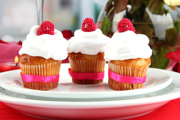 Delicious cupcakes with cream air on festive table close-up