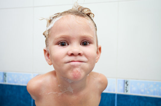 Cute four year old girl taking a relaxing bath