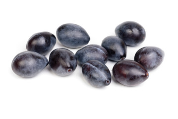 Some fresh blue plums on the white background