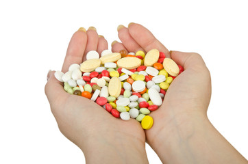 Hands holding pills on white