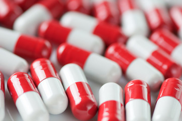 Close-up of red and white capsules, horizontal shot