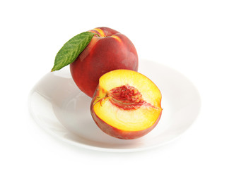 Single fresh ripe peach on the dish