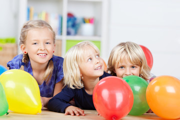 Fototapeta na wymiar Trzy dziewczyny gry z kolorowych balonów