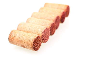 Six wine corks in a line