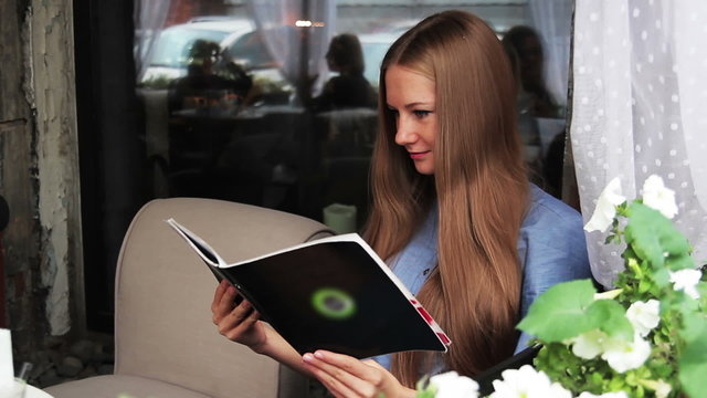 girl with a menu in a cafe
