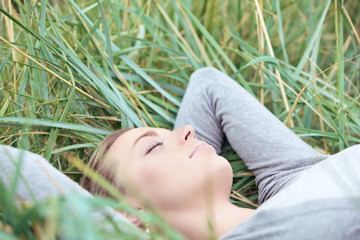 Serene woman sleeping in grass