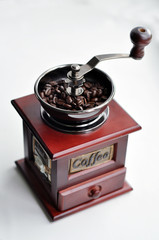 Old-fashioned coffee grinder with coffee beans