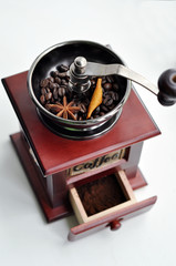 Old-fashioned coffee grinder with coffee beans