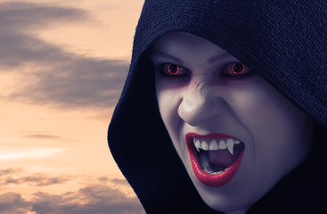 angry female vampire at sunset - obrazy, fototapety, plakaty