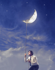 Businessman Holding the Moon