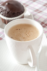 Chocolate muffins and coffee cup on table 