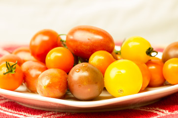 Plate of mixed tomatoes on cloth