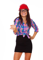 A girl in glasses is wearing a hard hat