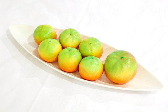 Oranges on white plate with white background