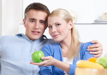 Wonderful woman offers an apple to her husband