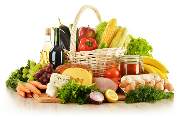 Groceries in wicker basket isolated on white