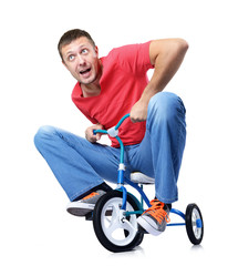 Curious man on a children's bicycle on white background