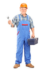 Manual worker holding a wrench and tool box
