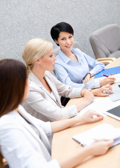 Female colleagues discuss business plan