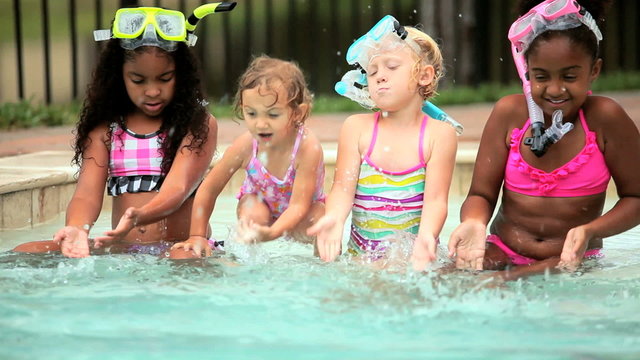Multi ethnic happy girls enjoying activity in swimming pool