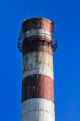 Industrial Smokestack on Blue Sky Background