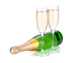 Lying champagne bottle and two glasses
