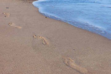 Footprints on the beach left behind